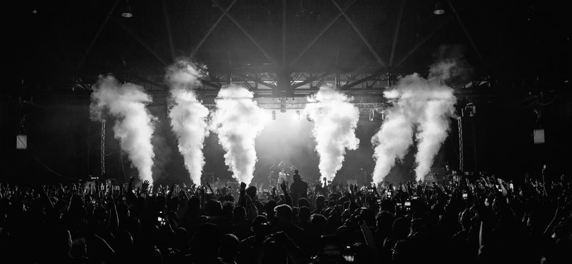 Electronic music crowd facing a live stage